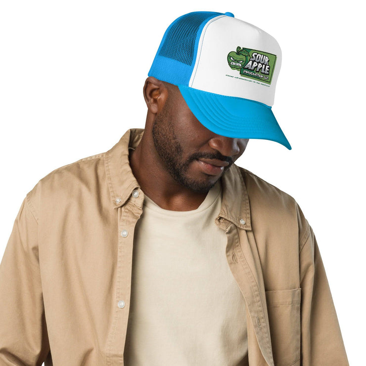 Man wearing a white and blue Sour Apple Foam Trucker Hat with green apple logo, perfect for casual and athletic settings.