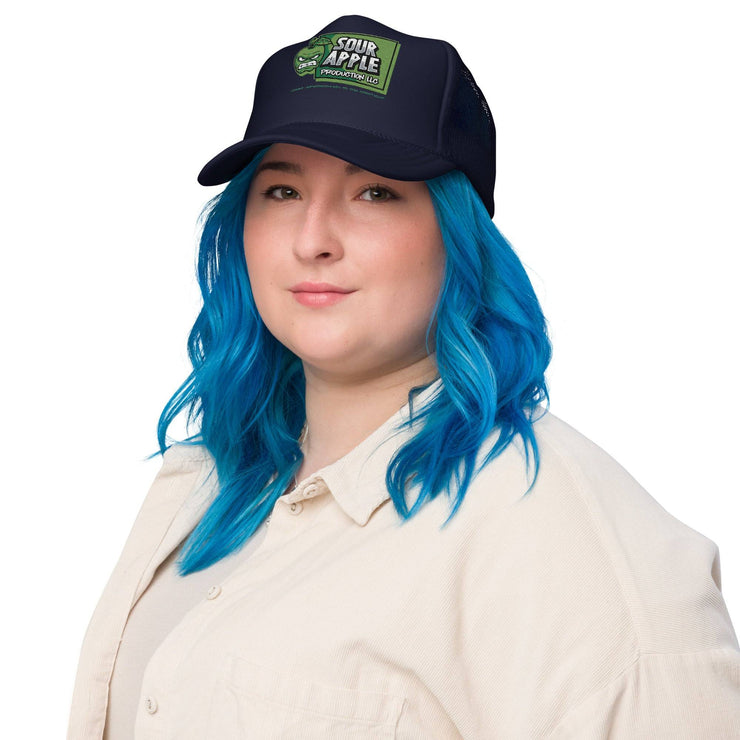 Model wearing a navy Sour Apple Foam Trucker Hat with green apple logo, perfect for casual and athleisure outfits.