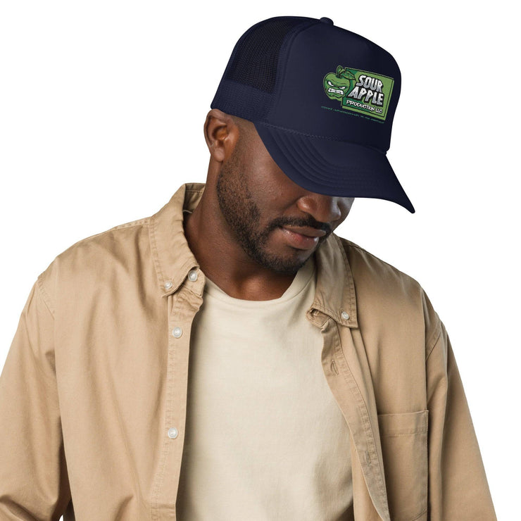 Man wearing a navy Sour Apple Foam Trucker Hat with green apple logo, ideal for sports fans and casual style.